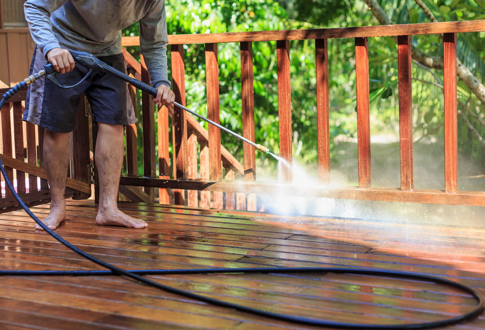 man do a soft washing on timber