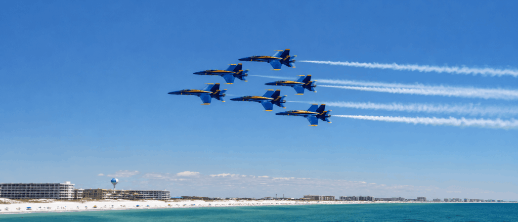 Jets over blue sunny coastline aerial display